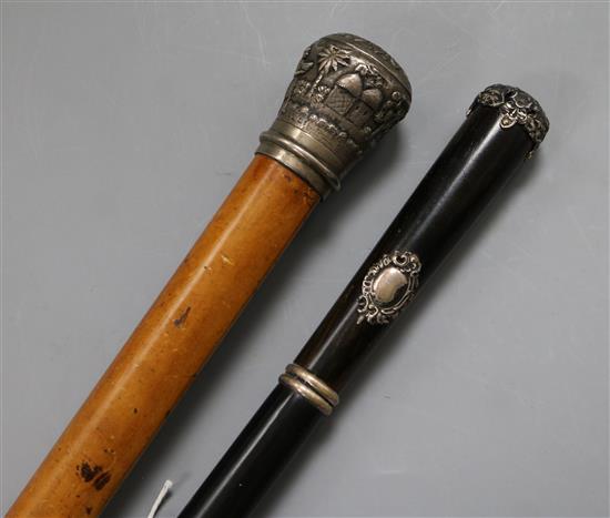 A malacca walking cane with Indian white metal embossed finial and a Spanish rosewood cane with white metal mounts longest 99cm